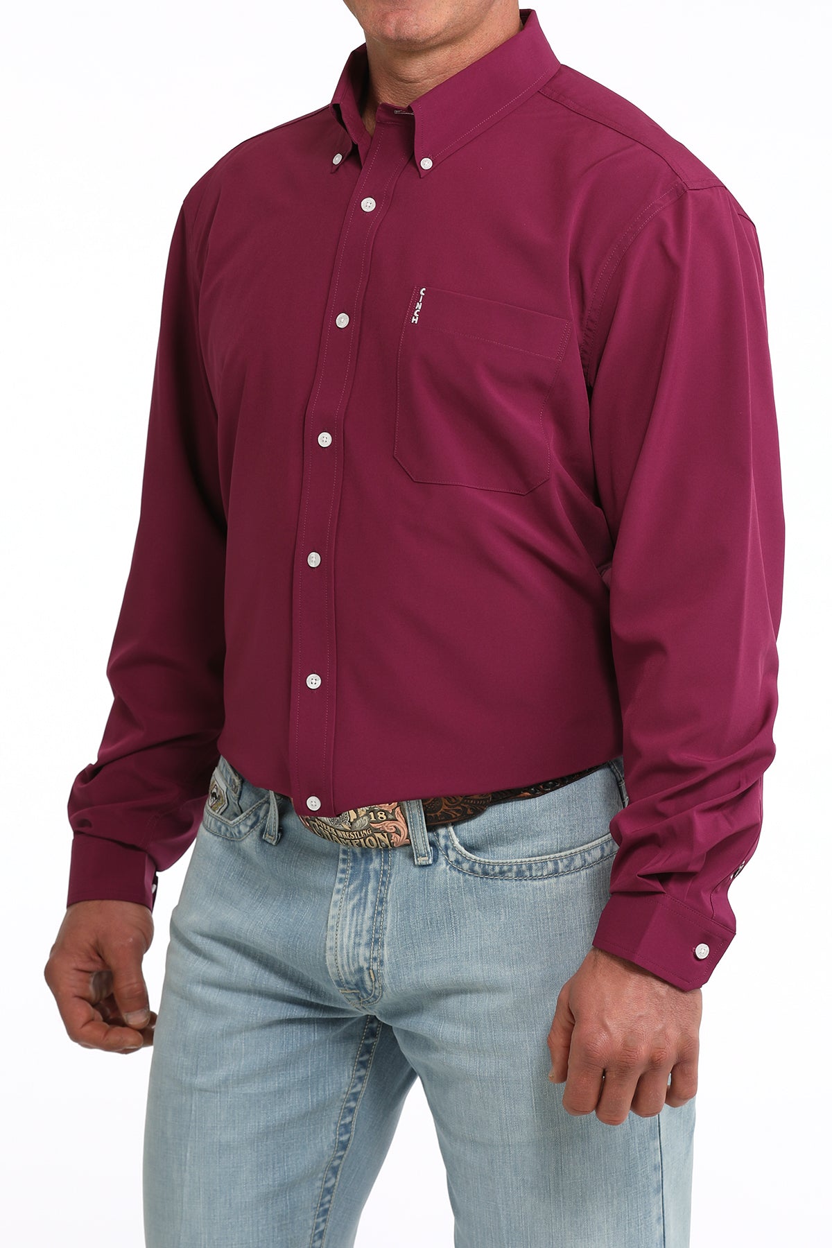 Man wearing a maroon button-up Cinch shirt and light blue jeans on a white background