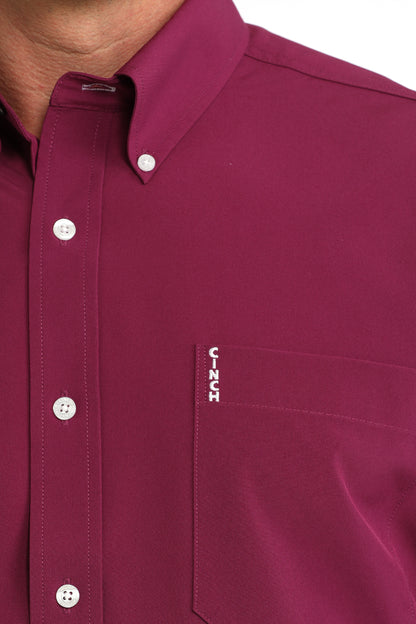 Close-up of a maroon Cinch shirt with a visible brand logo on a white background