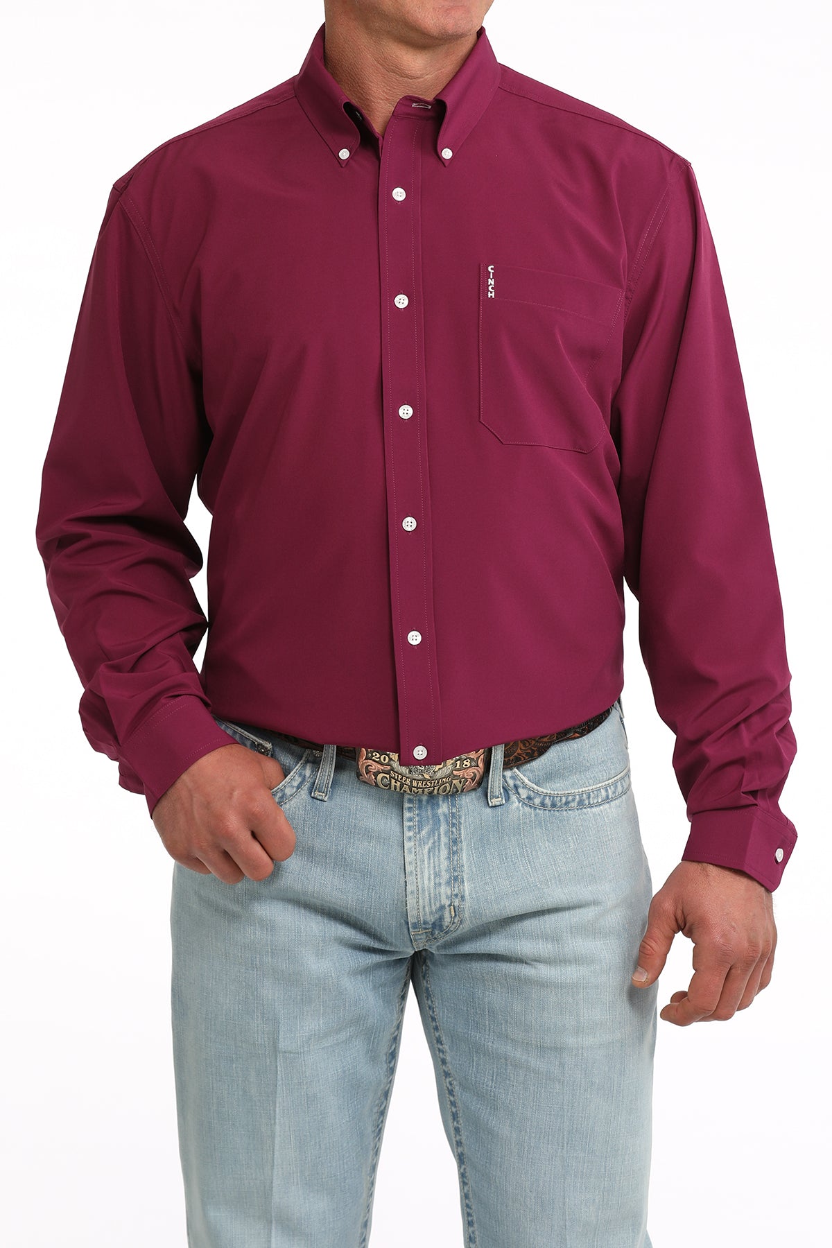 Man wearing a maroon button-up Cinch shirt and light blue jeans on a white background
