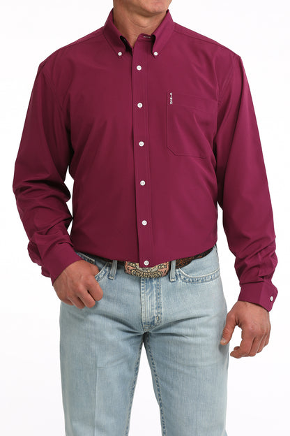 Man wearing a maroon button-up Cinch shirt and light blue jeans on a white background