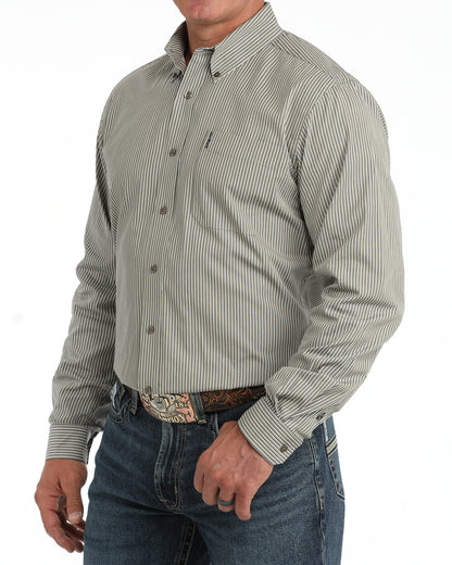 A man wearing a long-sleeve button-down Cinch shirt with thin vertical gray and white stripes, paired with blue jeans and a patterned belt, shown from the waist up against a white background.