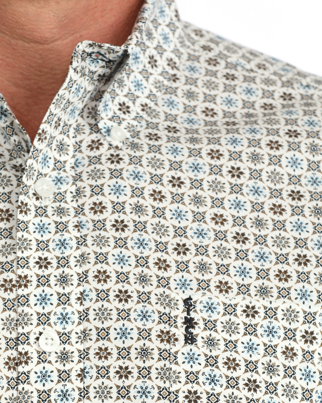 man wearing a cream floral Cinch shirt on a white background