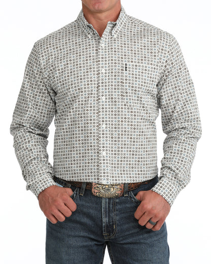 man wearing a cream floral print Cinch shirt and blue jeans on a white background