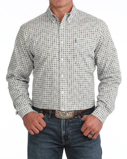 man wearing a cream floral print Cinch shirt and blue jeans on a white background