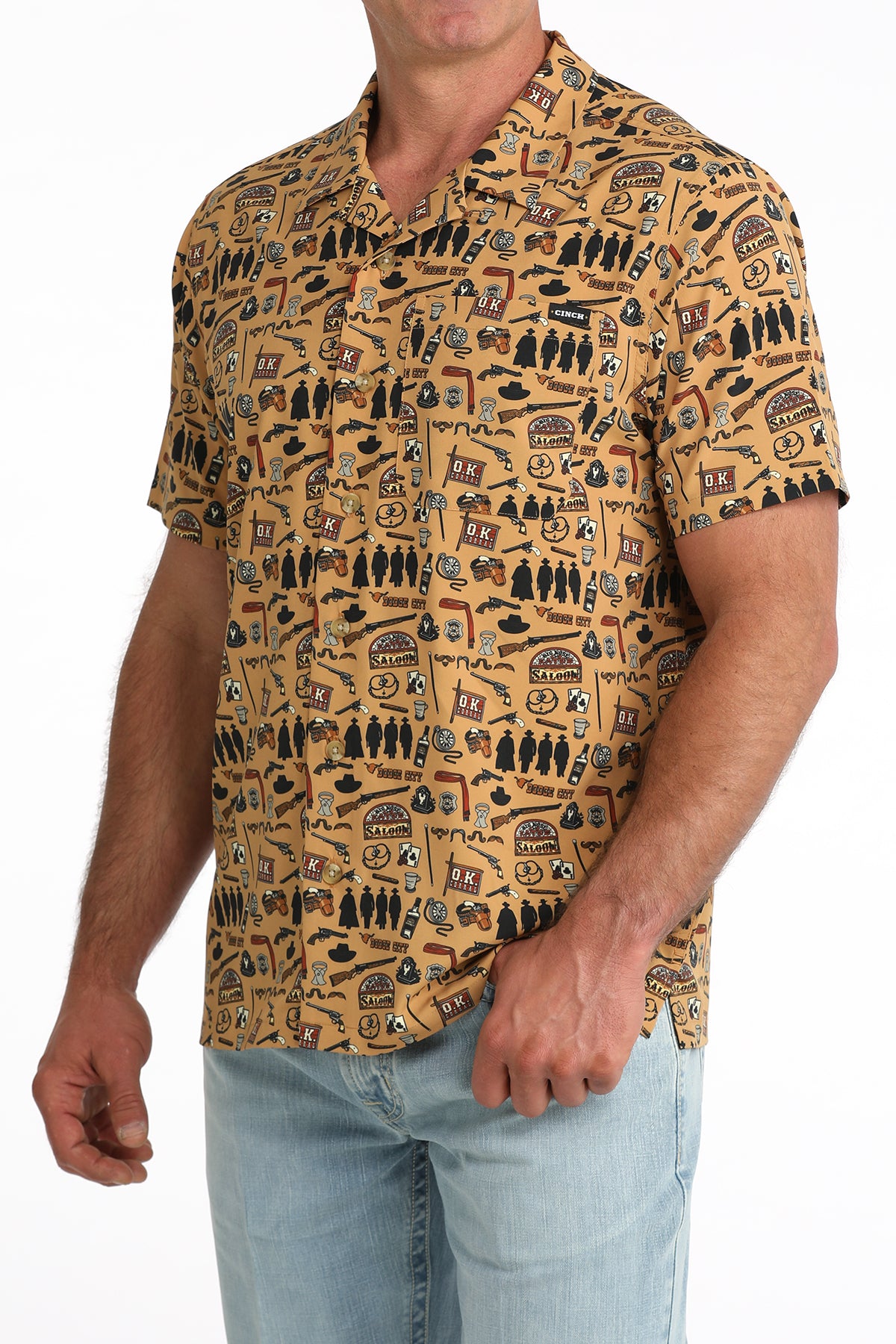 man wearing a brown printed Cinch shirt and blue jeans on a white background