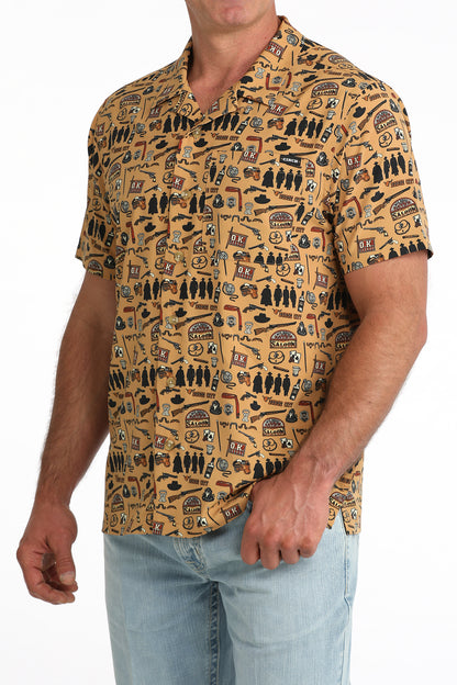 man wearing a brown printed Cinch shirt and blue jeans on a white background