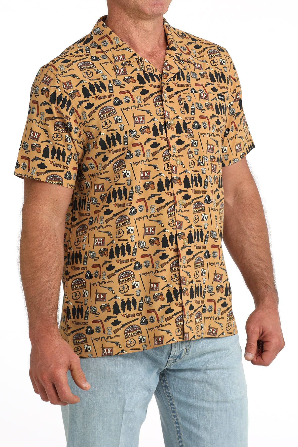man wearing a brown printed Cinch shirt and blue jeans on a white background