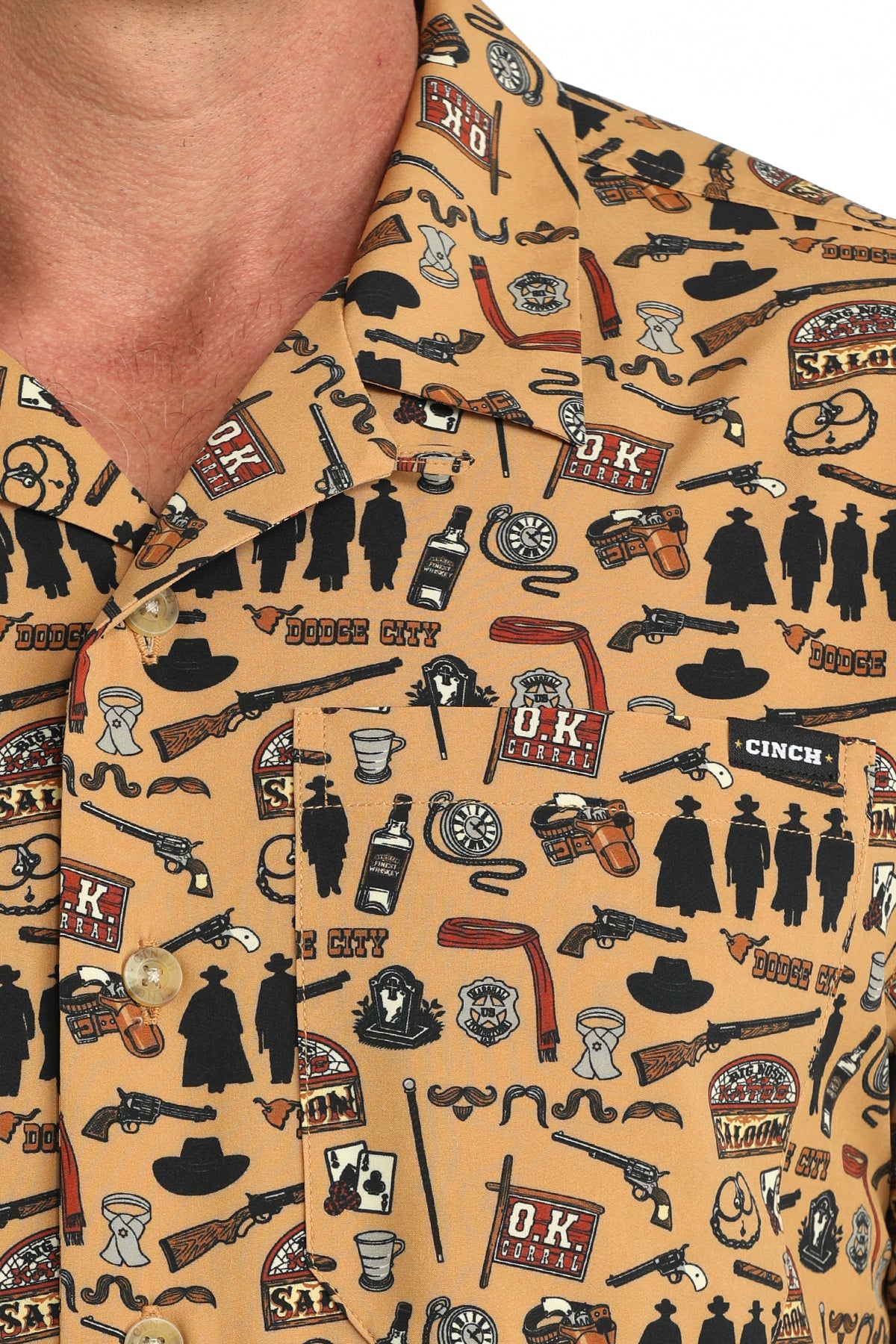 man wearing a brown printed Cinch shirt on a white background