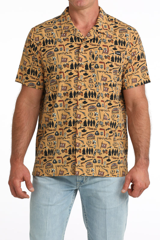 man wearing a brown printed Cinch shirt and blue jeans on a white background