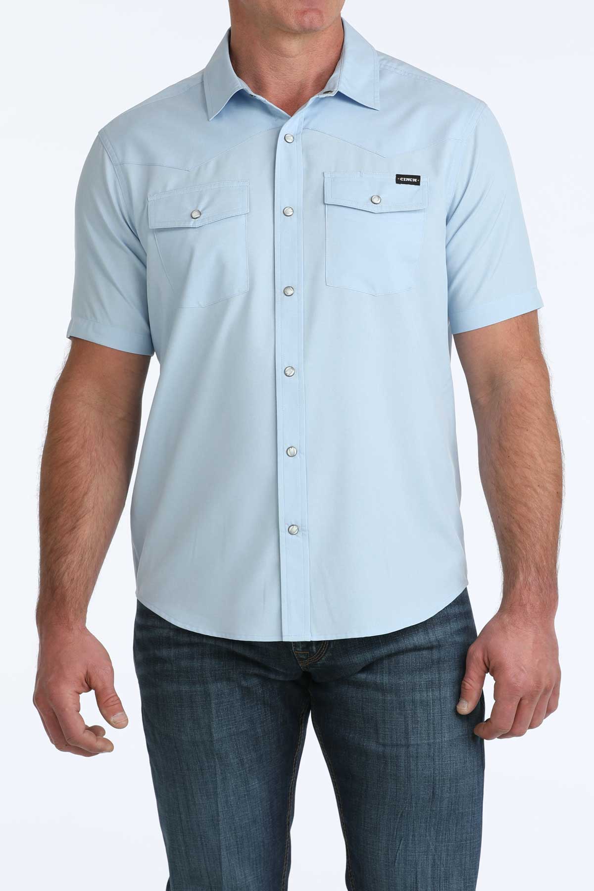 Light blue short-sleeve button-up 'Cinch' shirt worn by a person on a white background
