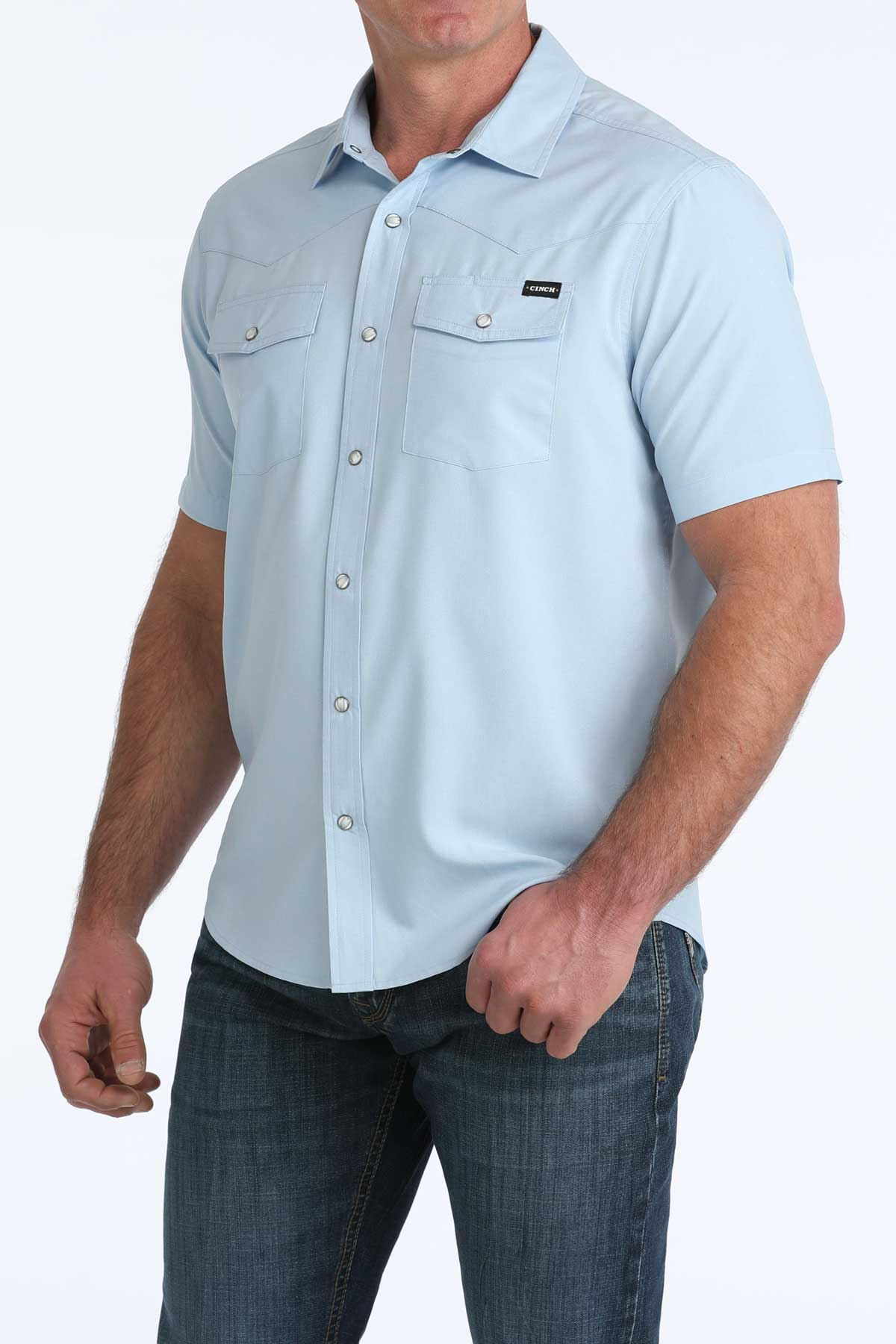 Light blue short-sleeve button-up 'Cinch' shirt worn by a person on a white background