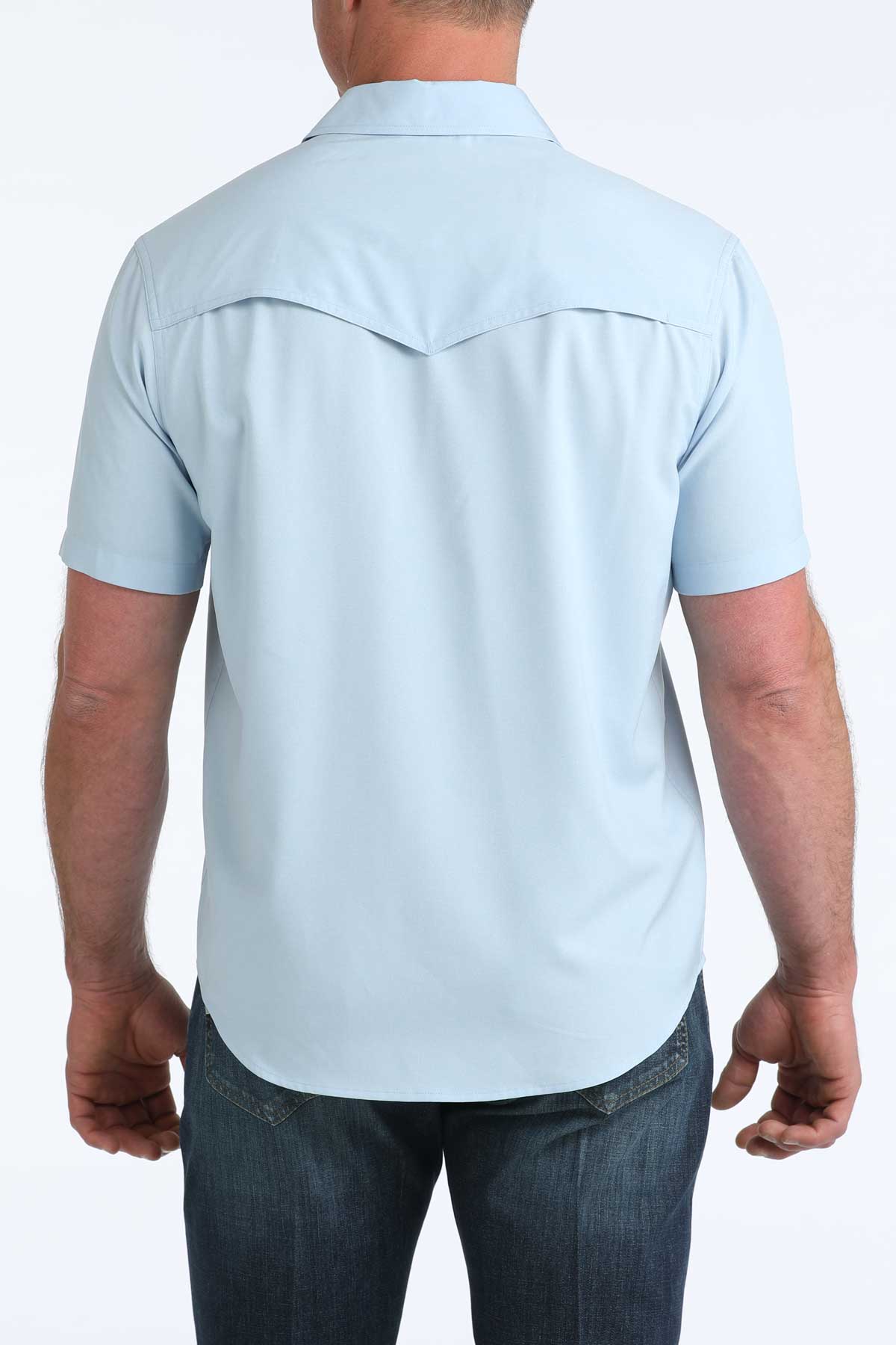 Light blue short-sleeve 'Cinch' shirt worn by a person on a white background