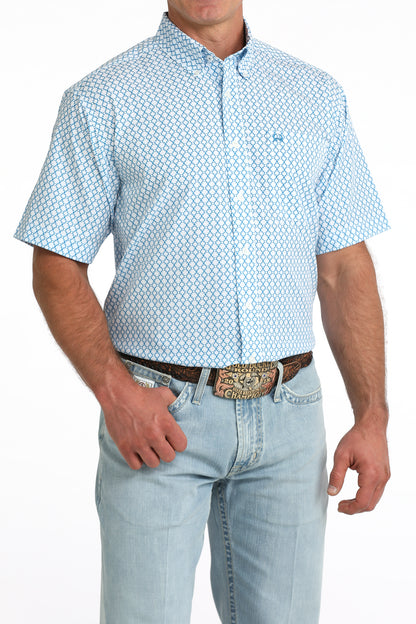 man wearing a blue printed shirt and blue jeans on a white background