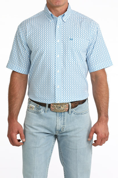 man wearing a blue printed shirt and blue jeans on a white background