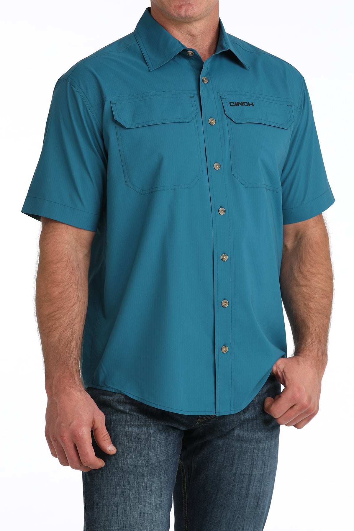 Teal short-sleeve Cinch shirt worn by a person on a white background