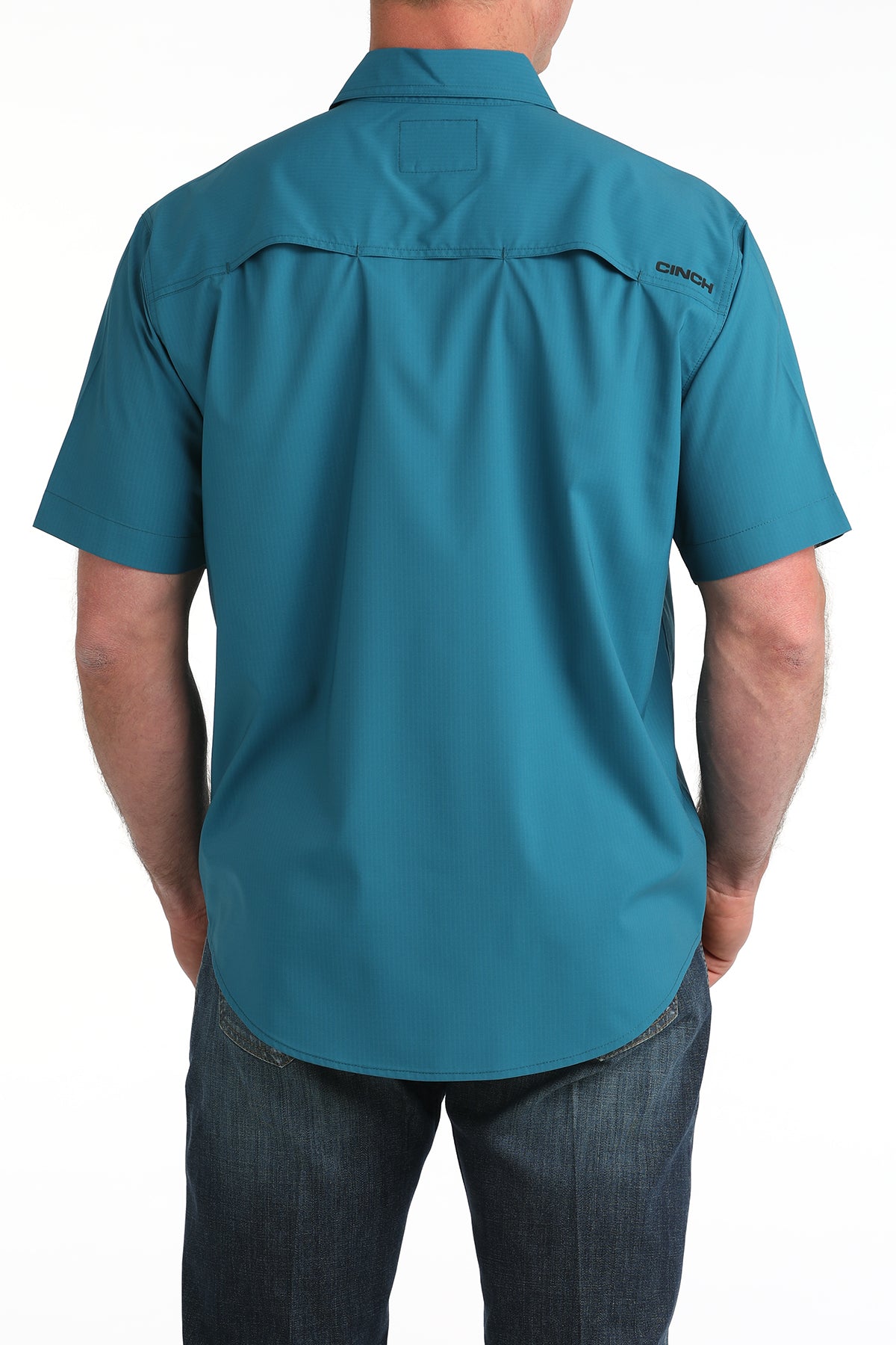 Teal short-sleeve Cinch shirt worn by a person on a white background