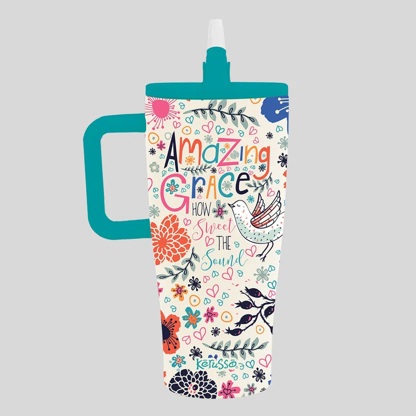 A tall handled Kerusso tumbler with a teal handle and lid, featuring a white body decorated with colorful floral illustrations and the words 'Amazing Grace How Sweet It Is' on a light gray background.