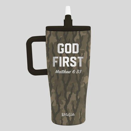 A tall insulated tumbler from Kerusso with a black handle and black lid, featuring a brown and green camouflage pattern. The front has the text 'GOD FIRST Matthew 6:33' in white, with the brand name 'keinsse' near the bottom, set against a solid gray background.