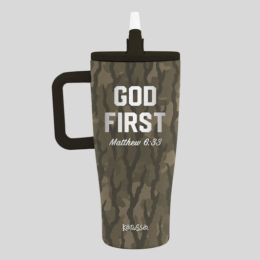 A tall insulated tumbler from Kerusso with a black handle and black lid, featuring a brown and green camouflage pattern. The front has the text 'GOD FIRST Matthew 6:33' in white, with the brand name 'keinsse' near the bottom, set against a solid gray background.