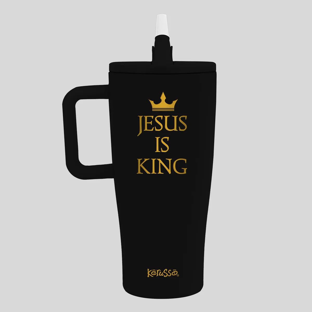 A black insulated tumbler with a handle and straw, featuring the gold text 'JESUS IS KING' with a crown graphic and the brand name 'Kerusso' near the bottom, shown on a light gray background.