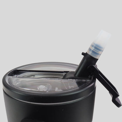 Close-up of a black insulated tumbler from Kerusso with a clear lid and a black straw-style drink spout with a translucent white cap, shown on a light gray background.