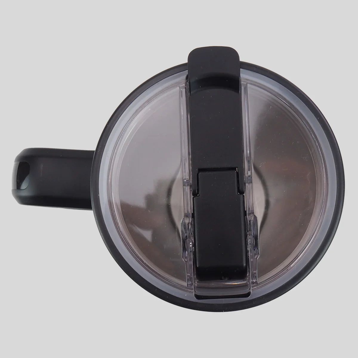 Top-down view of a black and clear plastic water bottle lid from Kerusso with a flip-up straw spout, shown against a solid light gray background.