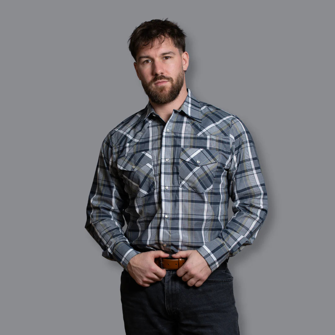 Man wearing a plaid shirt against a gray background
