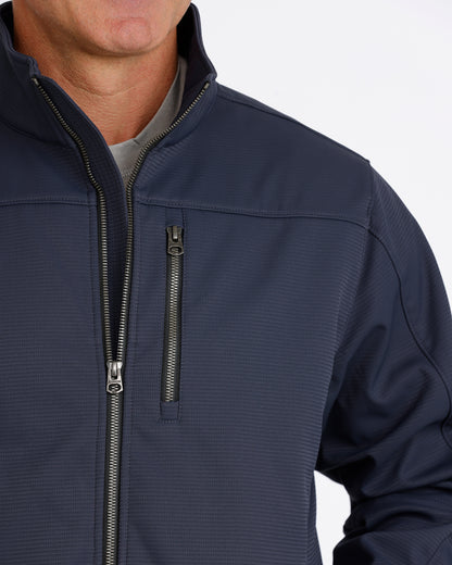 Man wearing a navy Cinch jacket on a white background