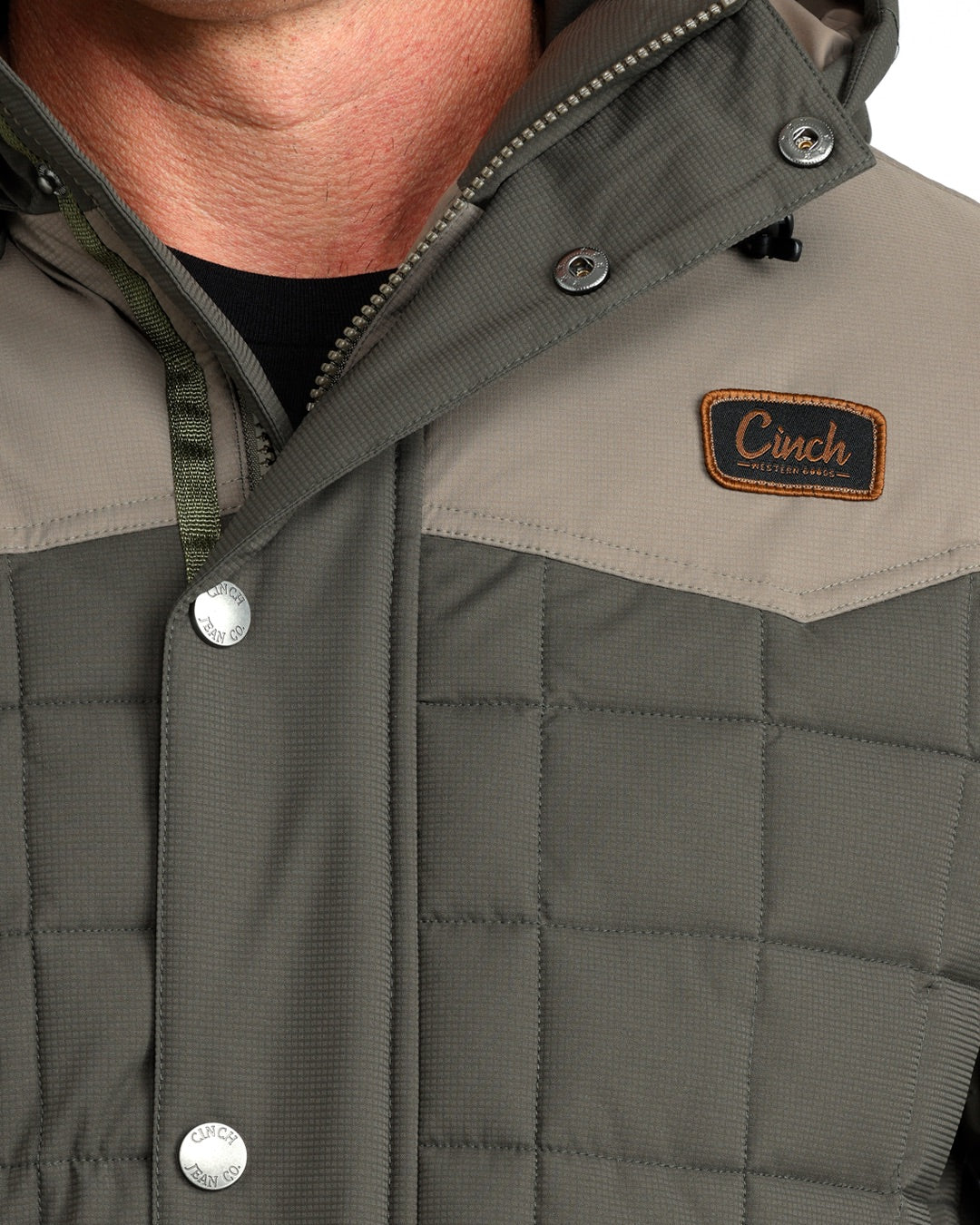 Close up of a man wearing a thick winter hacket by Cinch on a white background