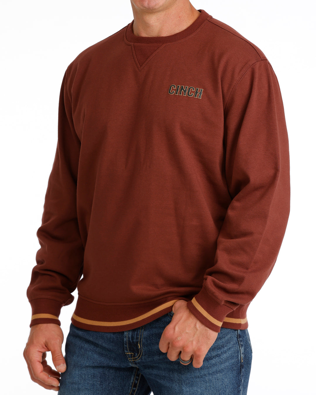 Burgundy sweatshirt with a Cinch logo on the chest worn by a person, against a white background