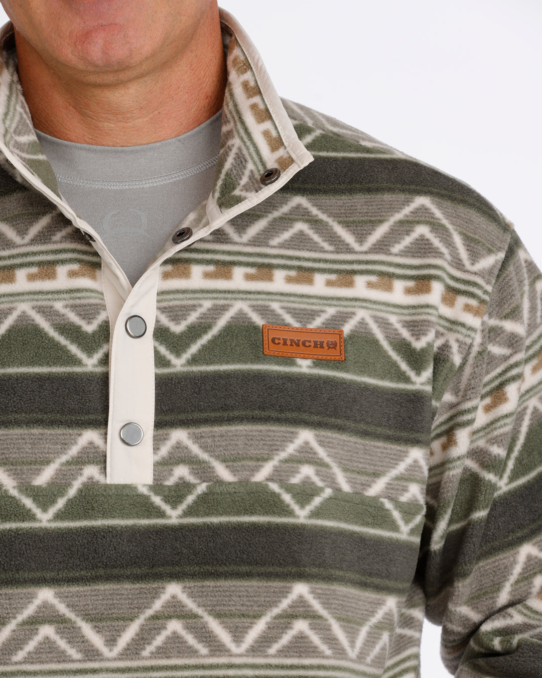 Man wearing an olive Cinch fleece pullover on a white background