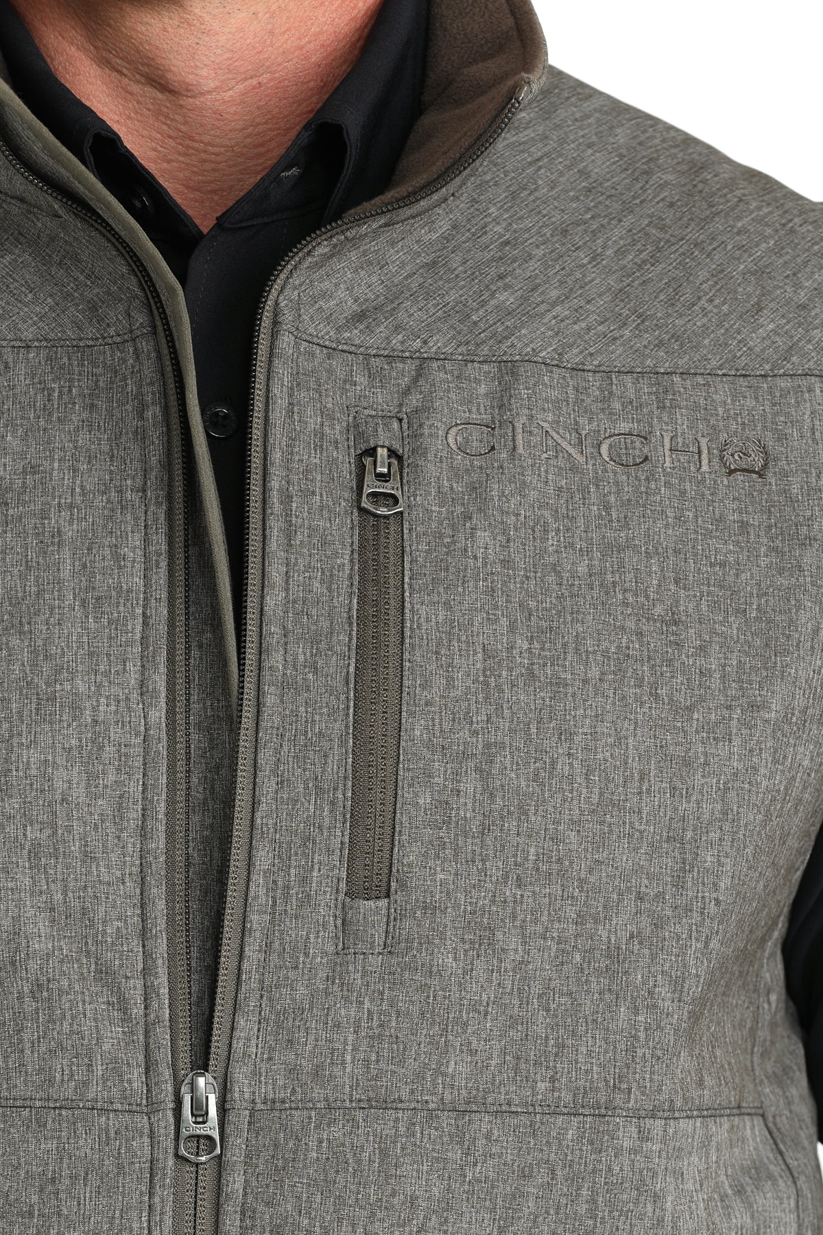 Man wearing Grey Cinch vest on a white background