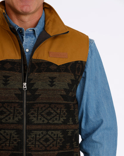man wearing a Cinch vest with aztec design and denim shirt on a white background