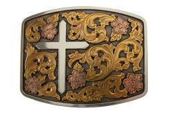 Decorative Nocona belt buckle with cross and floral designs on a white background