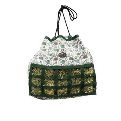 Drawstring bag with floral pattern and compartments filled with hay on a white background