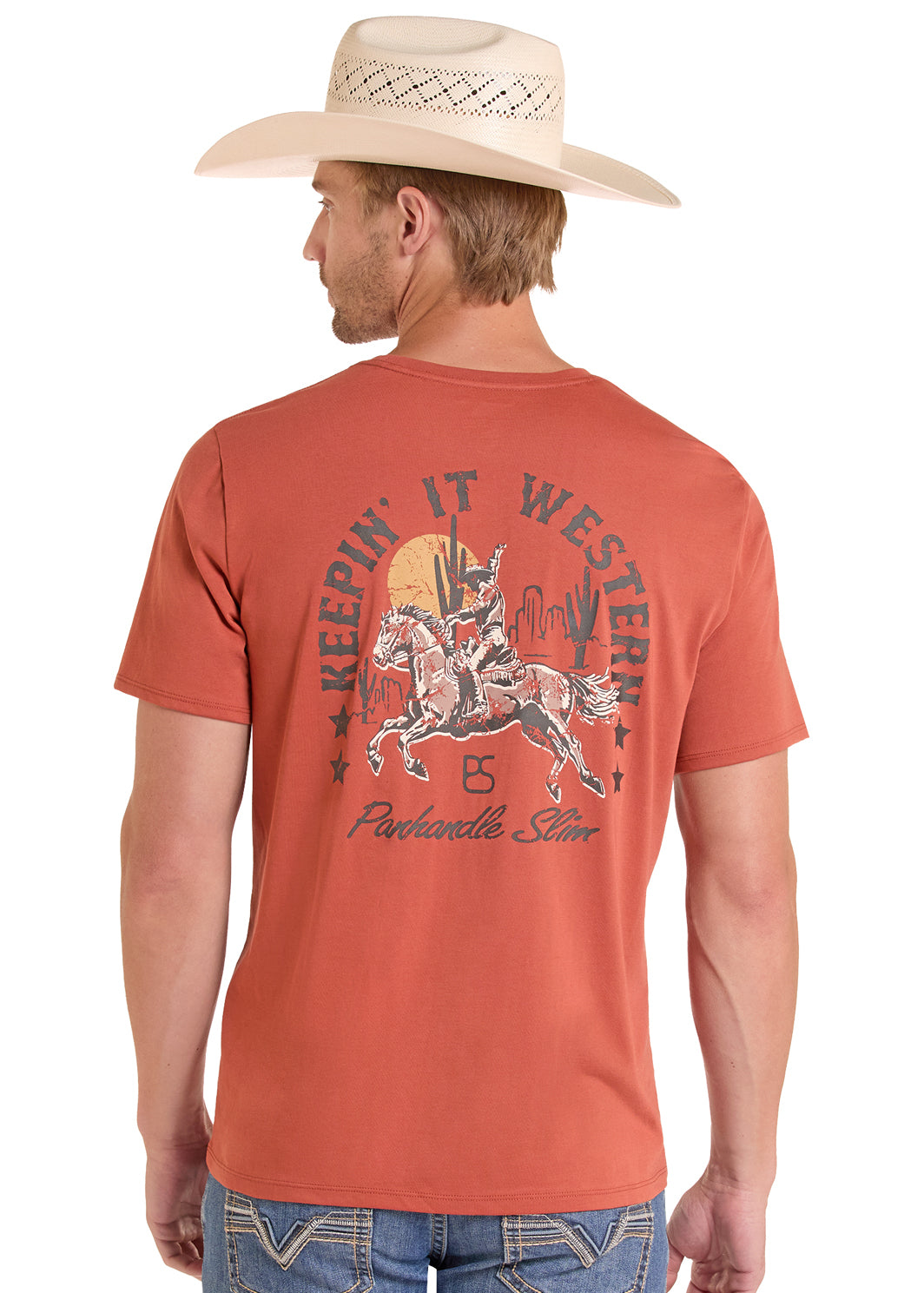 Man wearing a red Panhandle Slim t-shirt with a graphic design and text, standing against a white background