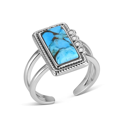 Silver Montana Silversmiths ring with a rectangular turquoise stone on a white background