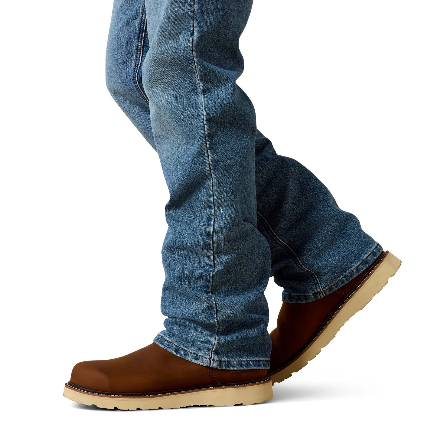 Ariat jeans and brown cowboy boots on a white background