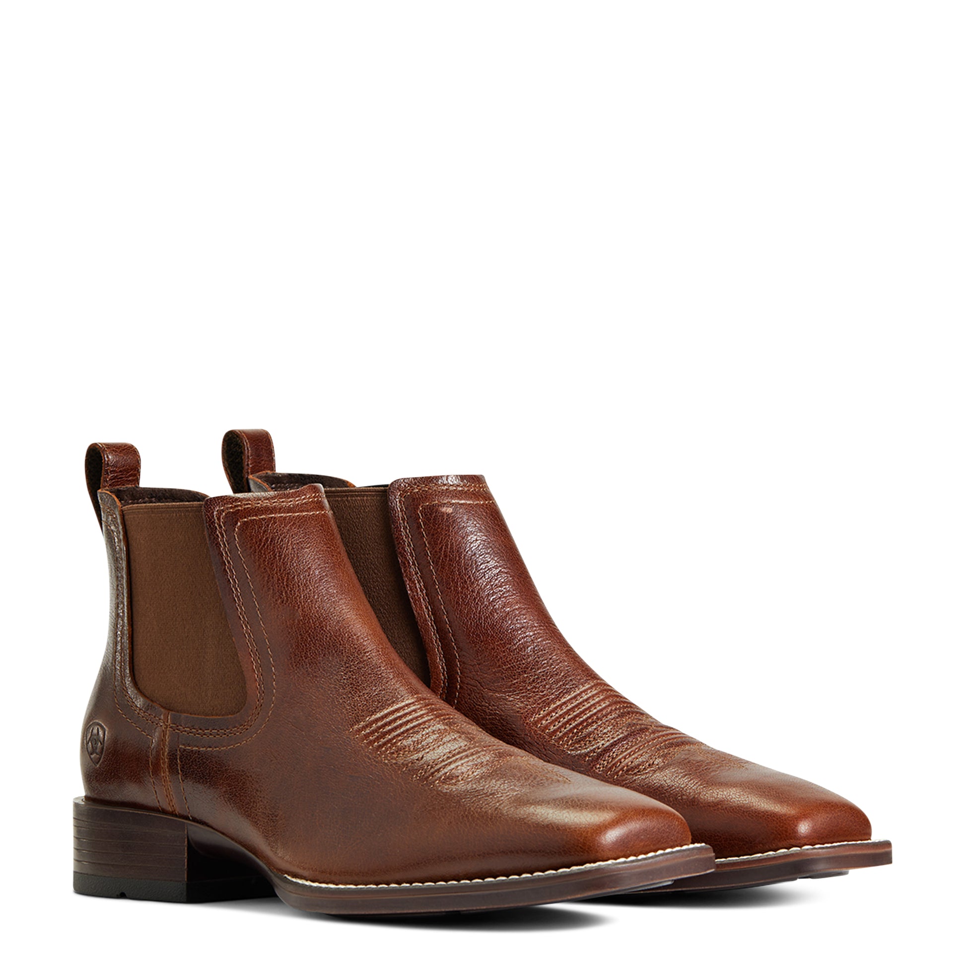 Pair of brown leather Chelsea boots on a white background