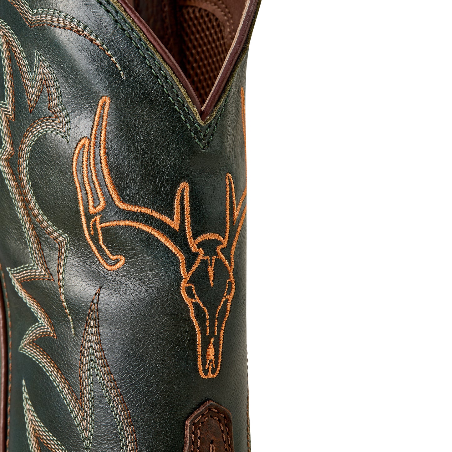 a close up of the shaft of a green cowboy boot with orange deer skull embroidery