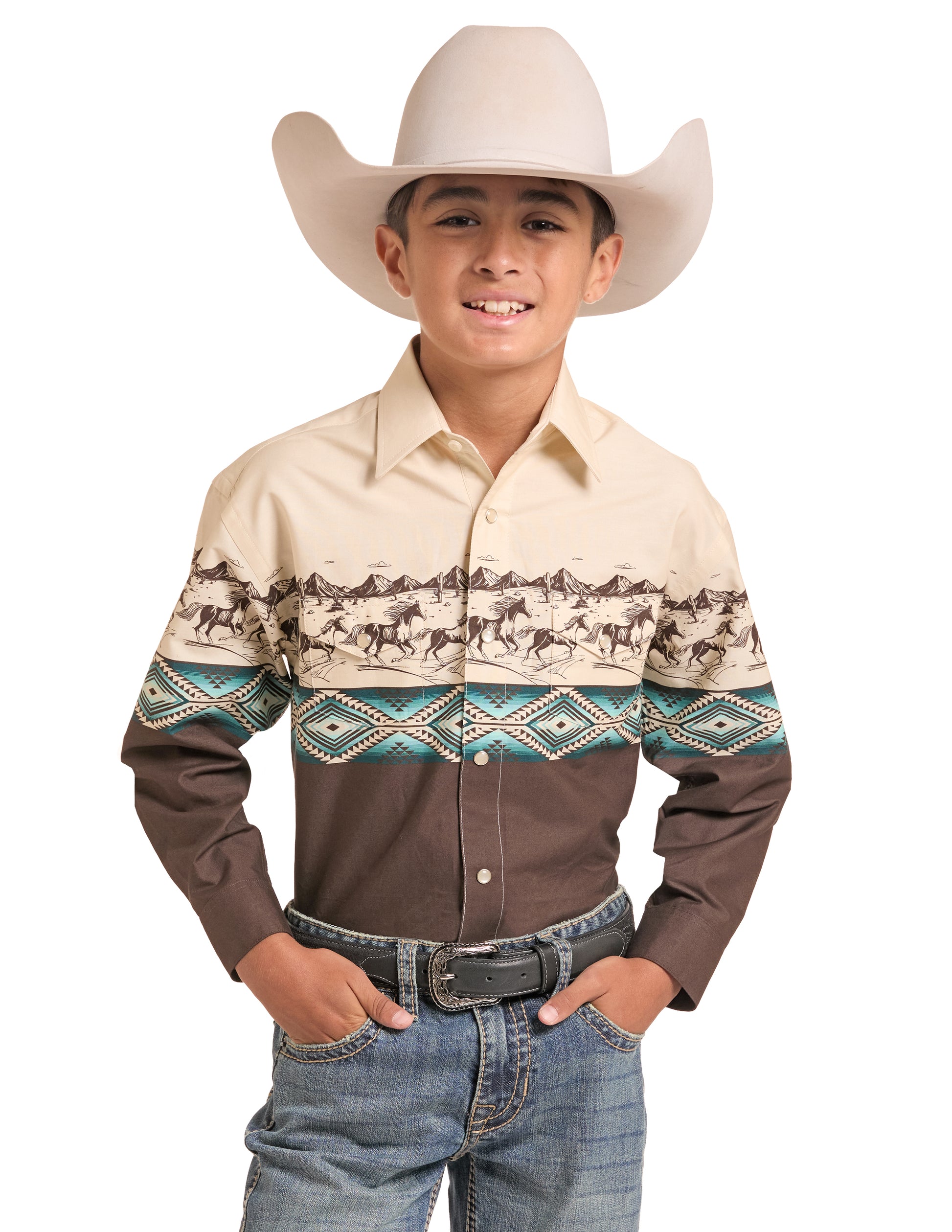 A young boy wearing a long-sleeve Panhandle Slim western shirt with a beige and brown design featuring a horse pattern and teal geometric accents, paired with a cream cowboy hat, belt, and jeans against a white background.