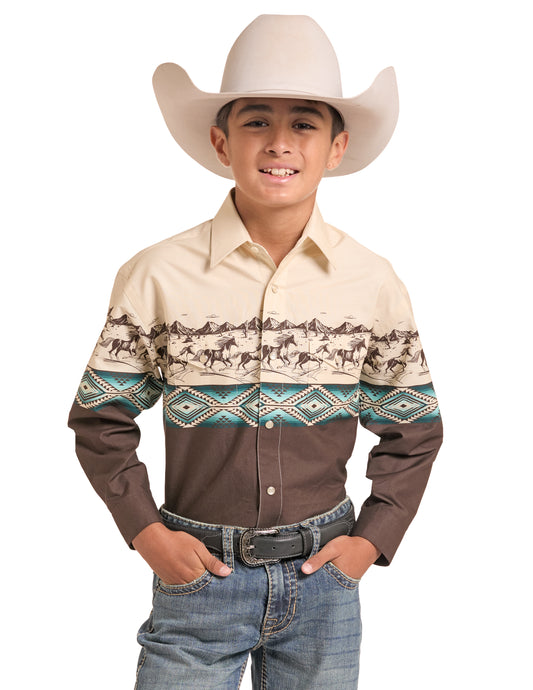 A young boy wearing a long-sleeve Panhandle Slim western shirt with a beige and brown design featuring a horse pattern and teal geometric accents, paired with a cream cowboy hat, belt, and jeans against a white background.