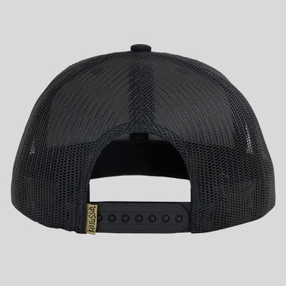 Kerusso black trucker hat shown from the back, featuring a black mesh back, black adjustable snapback strap, and a small gold brand tag.