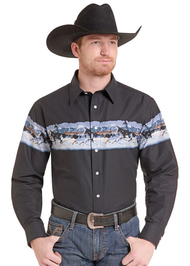 man wearing a black Panhandle Slim shirt with a western photo border, blue jeans and a black cowboy hat on a white background