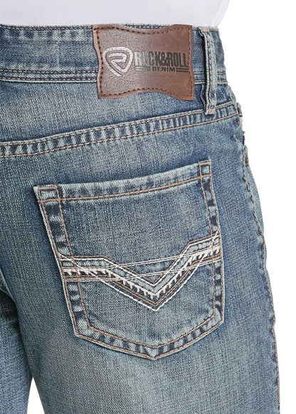 Close-up of the back waistband and pocket area of blue denim jeans, showing a brown leather Rock & Roll Denim brand patch and decorative contrast stitching on the back pocket.