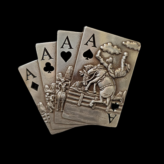 belt buckle with four aces and a bronc horse on a black background
