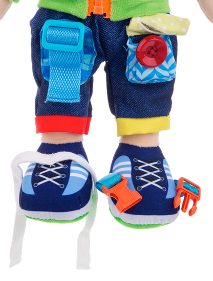 Colorful Ganz toy shoes with attached accessories on a stuffed doll on a white background
