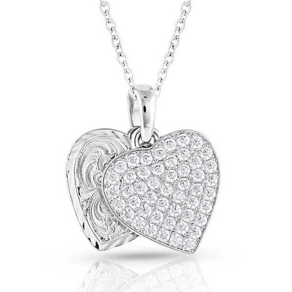 Heart-shaped Montana Silversmiths silver pendant with clear stones on a white background