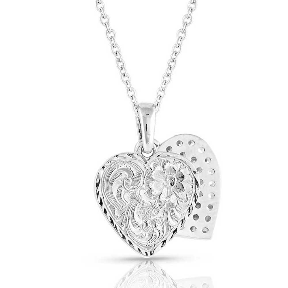 Montana Silversmiths Silver heart-shaped pendant with floral designs on a white background