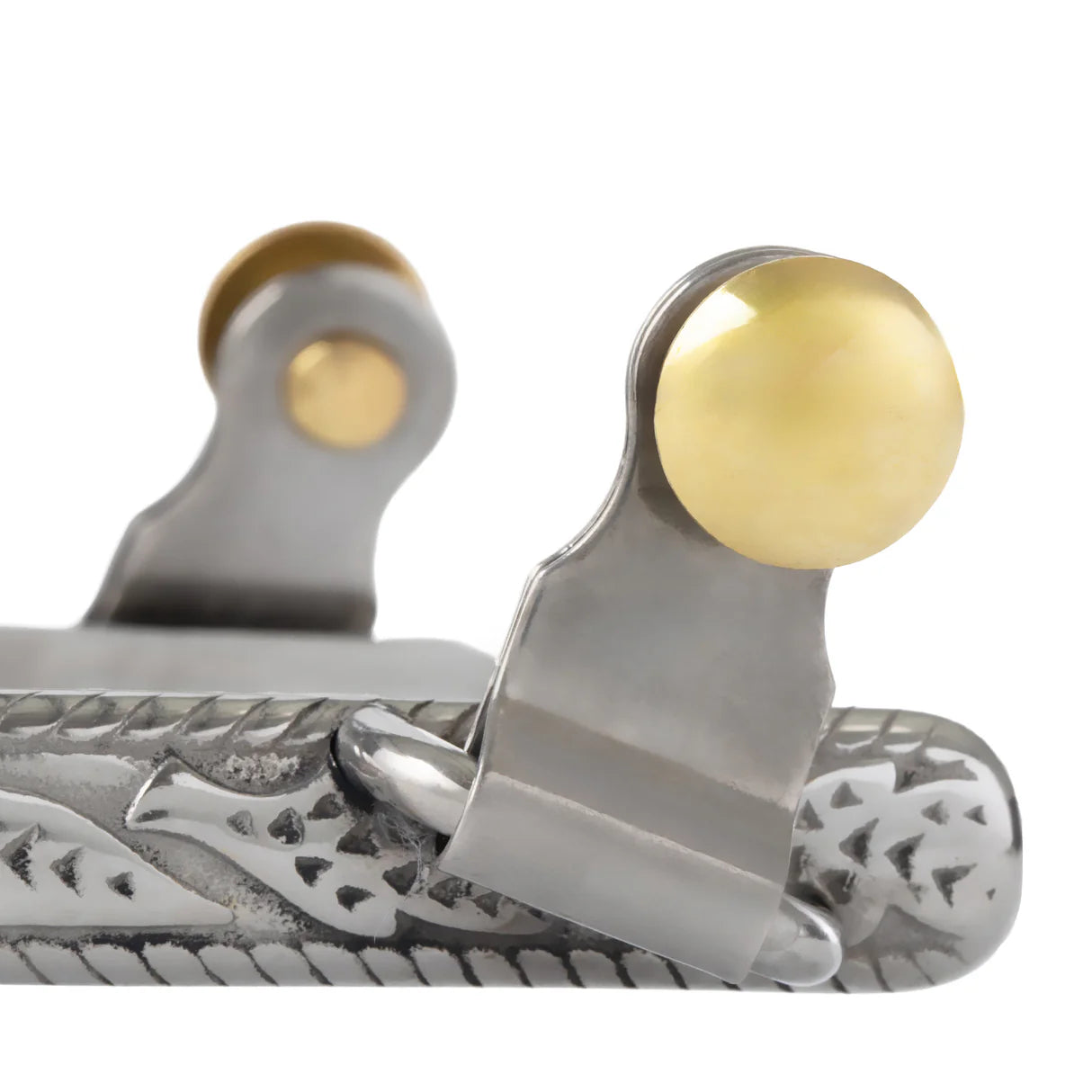 close up of a gold spur button and section of spur band on a white background